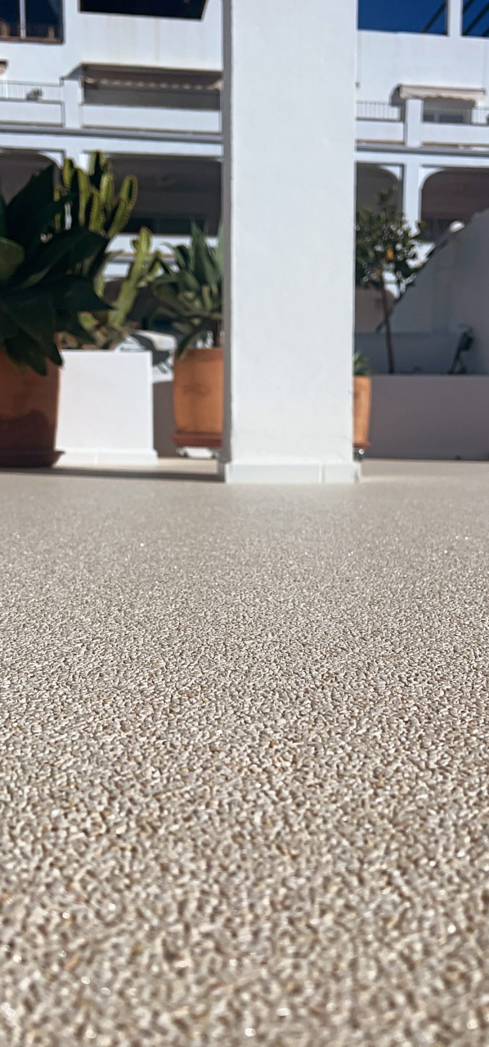 Pale marble stone carpet showing its natural aggregate texture on a terrace