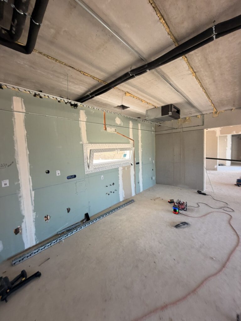 Interior of a new build with unfinished walls and exposed services